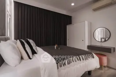 Modern bedroom with stylish decor and cozy ambiance, featuring a comfortable bed and elegant furnishings.