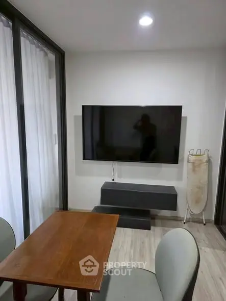 Modern living room with wall-mounted TV and stylish furniture