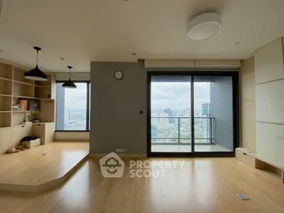 Spacious modern living room with city view and wooden flooring