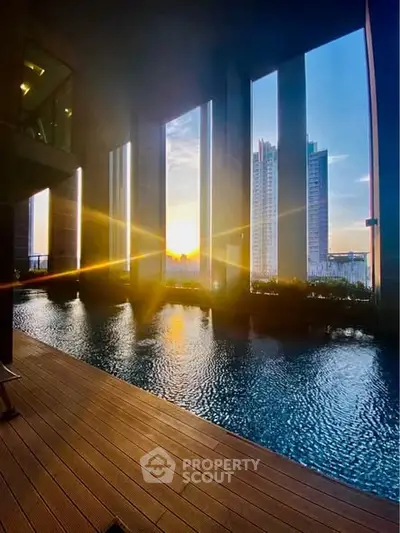 Luxurious high-rise pool with stunning sunset city view, perfect for relaxation and leisure.