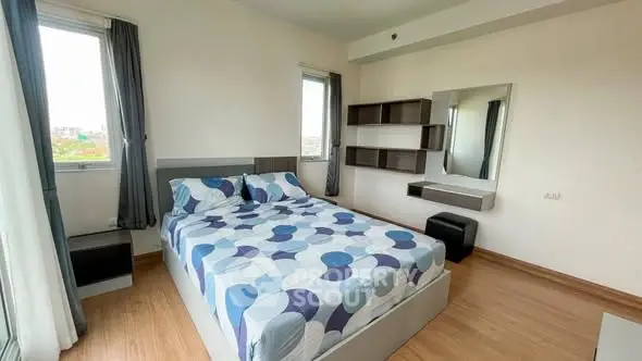 Modern bedroom with stylish decor and ample natural light