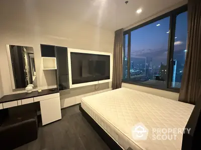 Modern bedroom with panoramic city views through large windows, featuring a sleek design, ample lighting, and a cozy ambiance perfect for urban living.