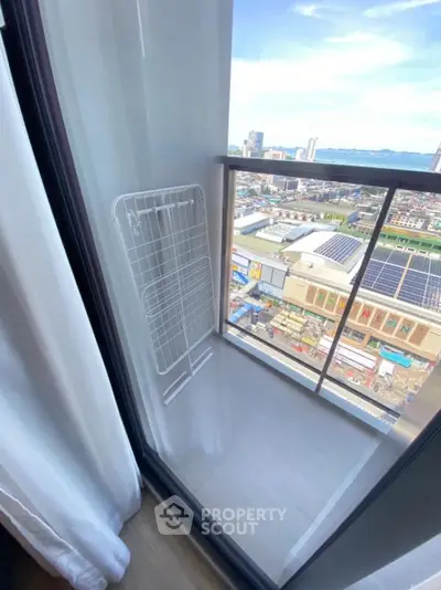 Modern balcony with city view and drying rack, perfect for urban living.