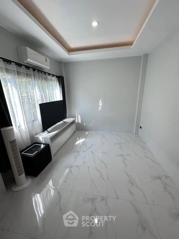 Modern living room with sleek marble flooring and large window for natural light.