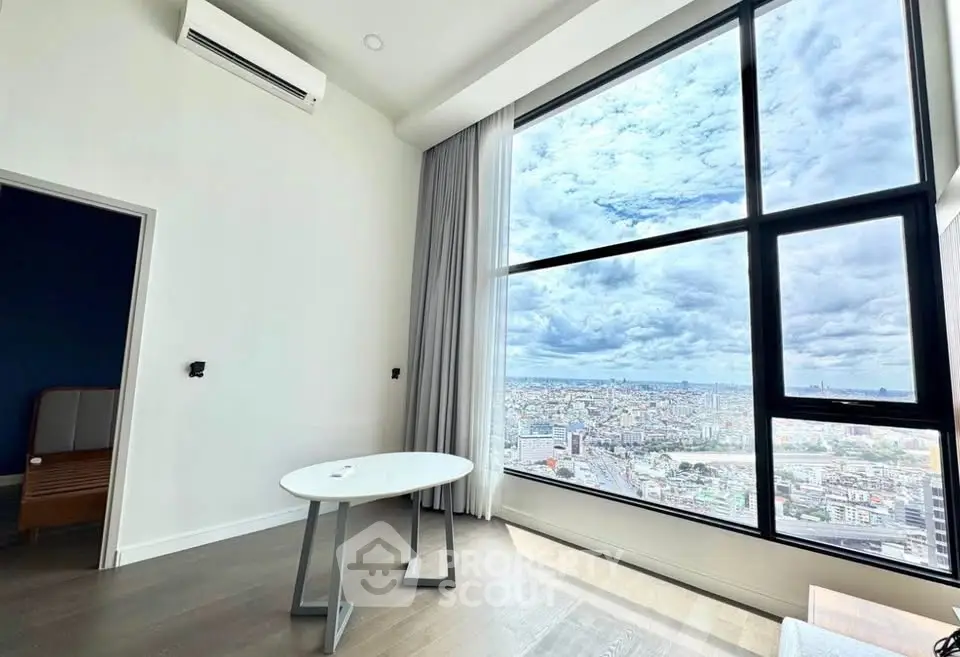 Stunning high-rise apartment with floor-to-ceiling windows offering breathtaking city views.