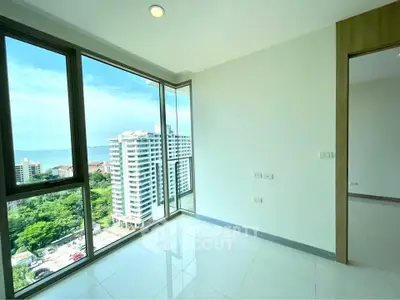 Bright corner unit with floor-to-ceiling windows offering stunning city and ocean views.
