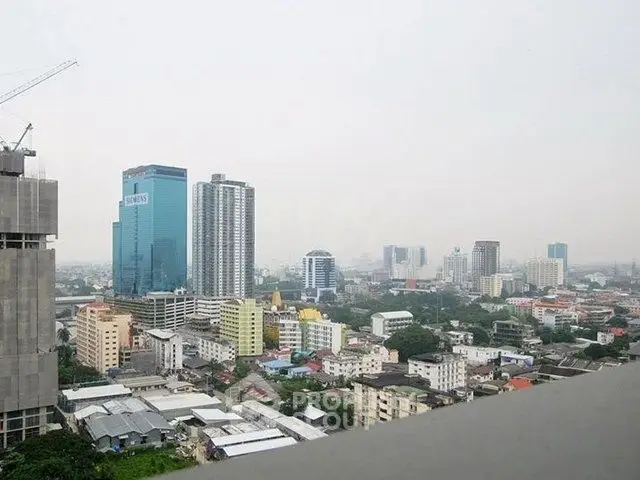 Stunning cityscape view from a high-rise building balcony showcasing urban skyline.