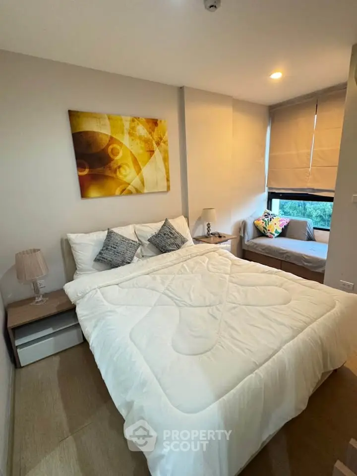 Cozy bedroom with modern decor and natural light in a stylish apartment.
