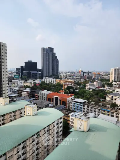 Stunning cityscape view from high-rise building showcasing urban skyline and residential architecture.