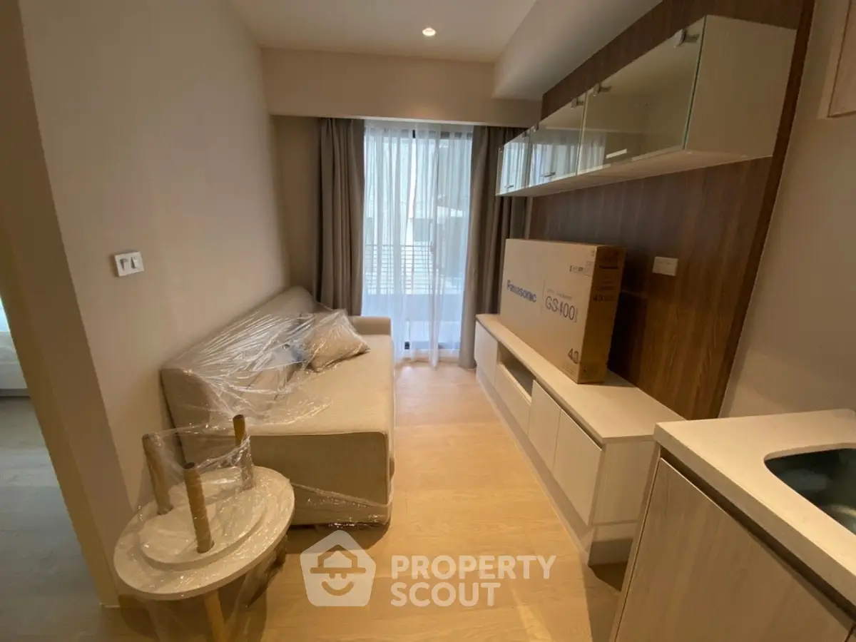 Modern living room with sleek furniture and natural light, perfect for cozy urban living.