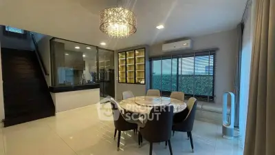 Elegant dining area with modern chandelier and open layout in a stylish home