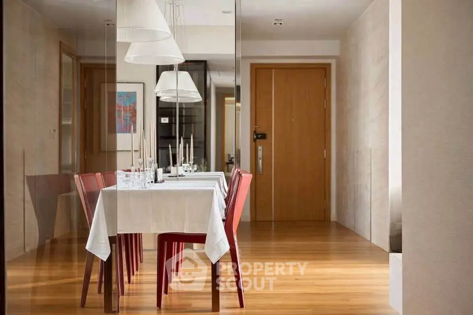 Elegant dining area with modern decor and wooden flooring in a stylish apartment.