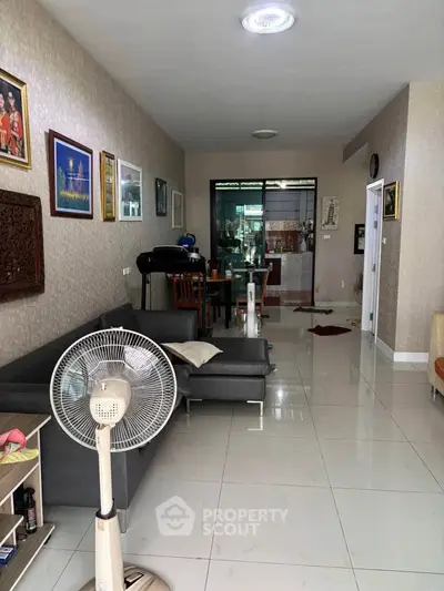 Spacious living room with modern decor and ample natural light, perfect for family gatherings.