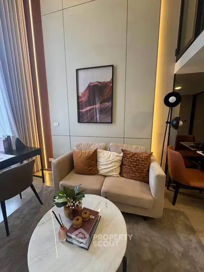 Modern living room with high ceilings, stylish decor, and cozy seating area.