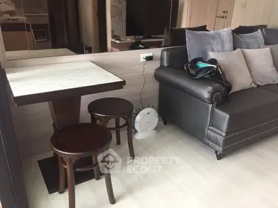 Modern living room with stylish sofa and dining area in a cozy apartment.