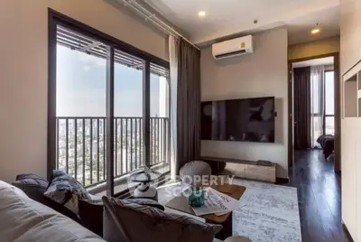 Modern living room with city view, large windows, and stylish decor in a high-rise apartment.
