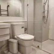 Modern bathroom with glass shower and sleek fixtures.