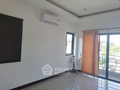 Spacious room with air conditioning and balcony access, perfect for modern living.