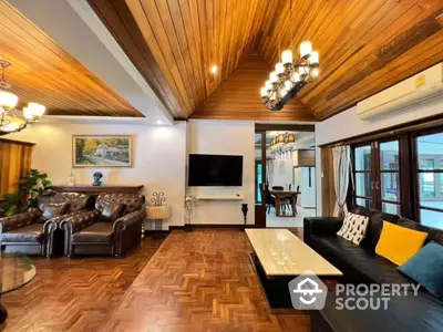 Luxurious living room with wooden ceiling and elegant leather sofas