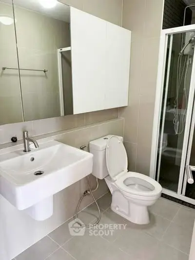 Modern bathroom with sleek fixtures and glass shower enclosure