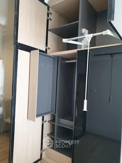 Modern wardrobe with sleek design and ample storage space in a stylish interior.