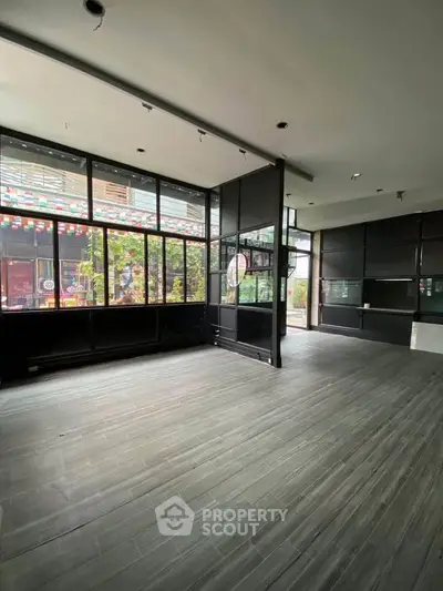 Spacious modern interior with large windows and sleek flooring, perfect for versatile use.