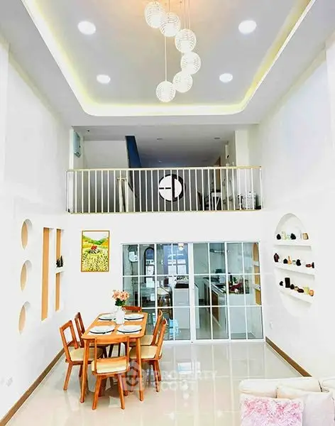 Stunning open-plan living and dining area with modern decor and high ceilings.