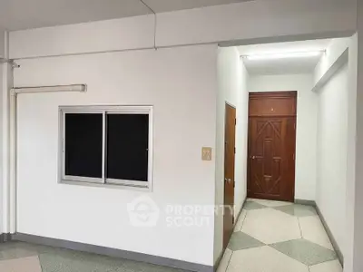 Spacious interior with minimalist design and wooden door, ideal for customization.