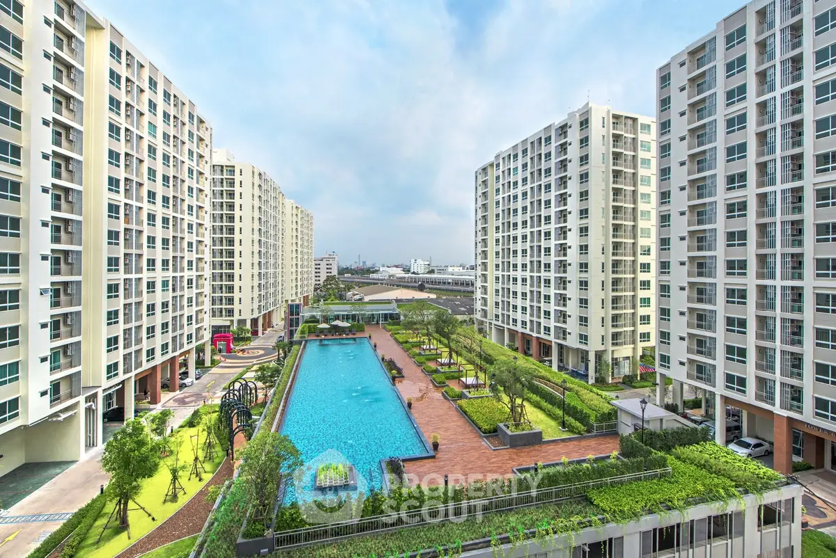 Luxurious apartment complex with a stunning pool and lush gardens, offering modern urban living.
