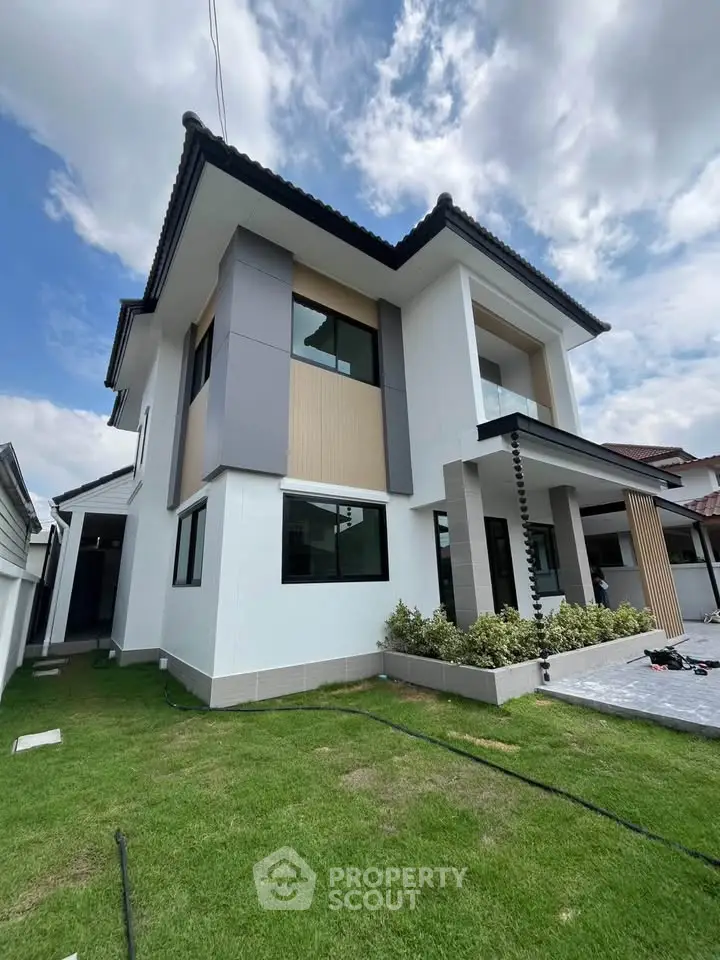 Modern two-story house with sleek design and lush green lawn