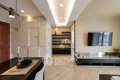 Modern living room with sleek design and open layout, featuring elegant lighting and stylish decor.