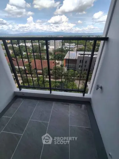 Stunning balcony view with modern railing overlooking lush greenery and cityscape.