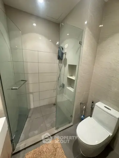 Modern bathroom with glass shower enclosure and sleek toilet design