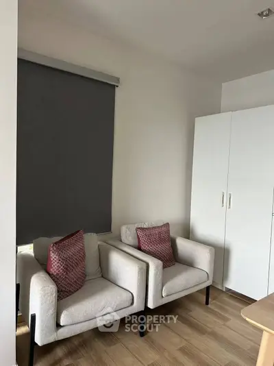 Cozy study room with modern armchairs and sleek storage cabinet