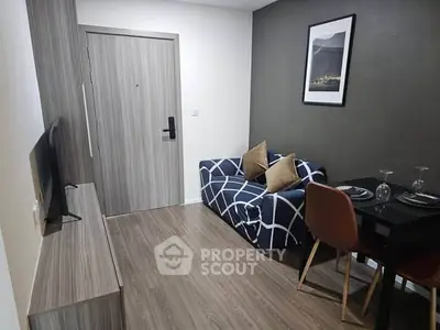 Modern living room with stylish decor and compact dining area, perfect for urban living.