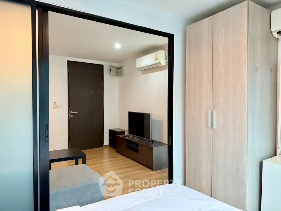 Modern apartment interior with sliding door and cozy living area