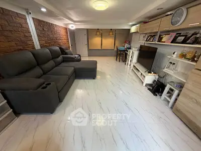 Spacious living room with modern decor and comfortable seating
