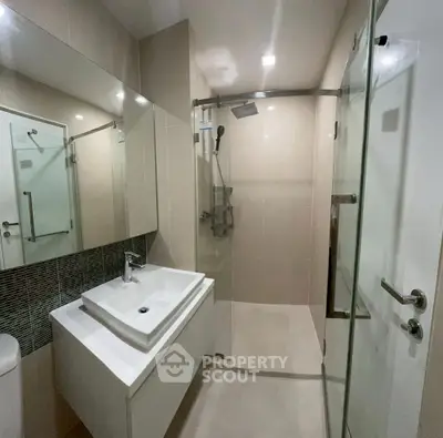 Modern bathroom with sleek fixtures and glass shower enclosure