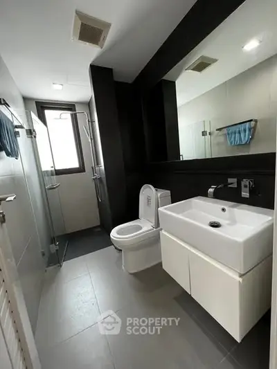 Modern bathroom with sleek fixtures and glass shower enclosure