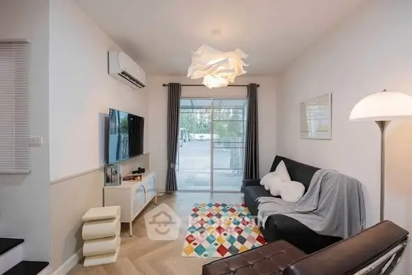 Charming living room with modern decor and large window view