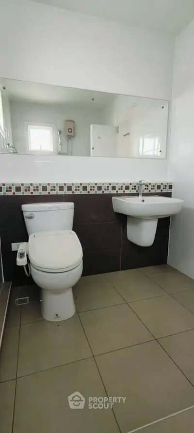 Modern bathroom with sleek fixtures and stylish tile accents.