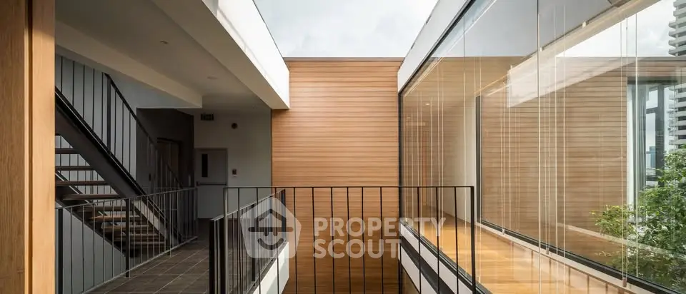 Modern architectural design with glass walls and wooden accents in a contemporary building.