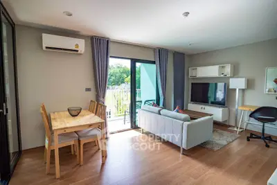 Modern living room with balcony access and stylish furniture