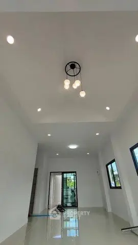 Spacious modern living room with elegant lighting and large windows