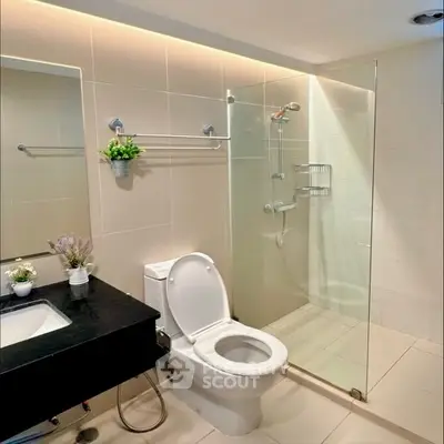 Modern bathroom with glass shower and sleek fixtures