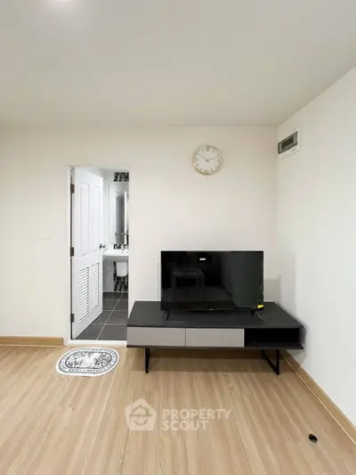 Modern living room with sleek TV stand and wooden flooring
