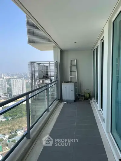 Spacious balcony with city view, perfect for relaxation and outdoor activities.