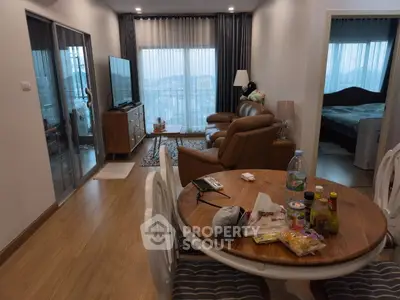 Spacious living room with modern decor and balcony view