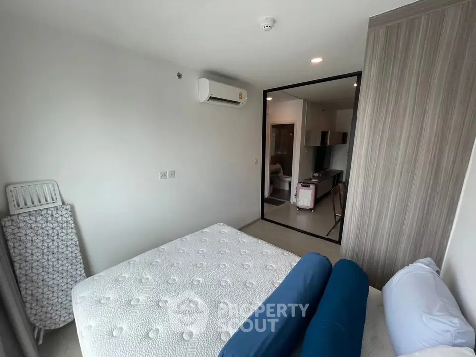 Modern bedroom with minimalist design and air conditioning in a stylish apartment.