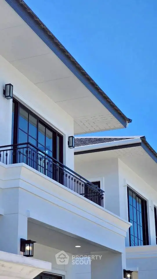 Stunning modern building exterior with large windows and elegant balcony design.